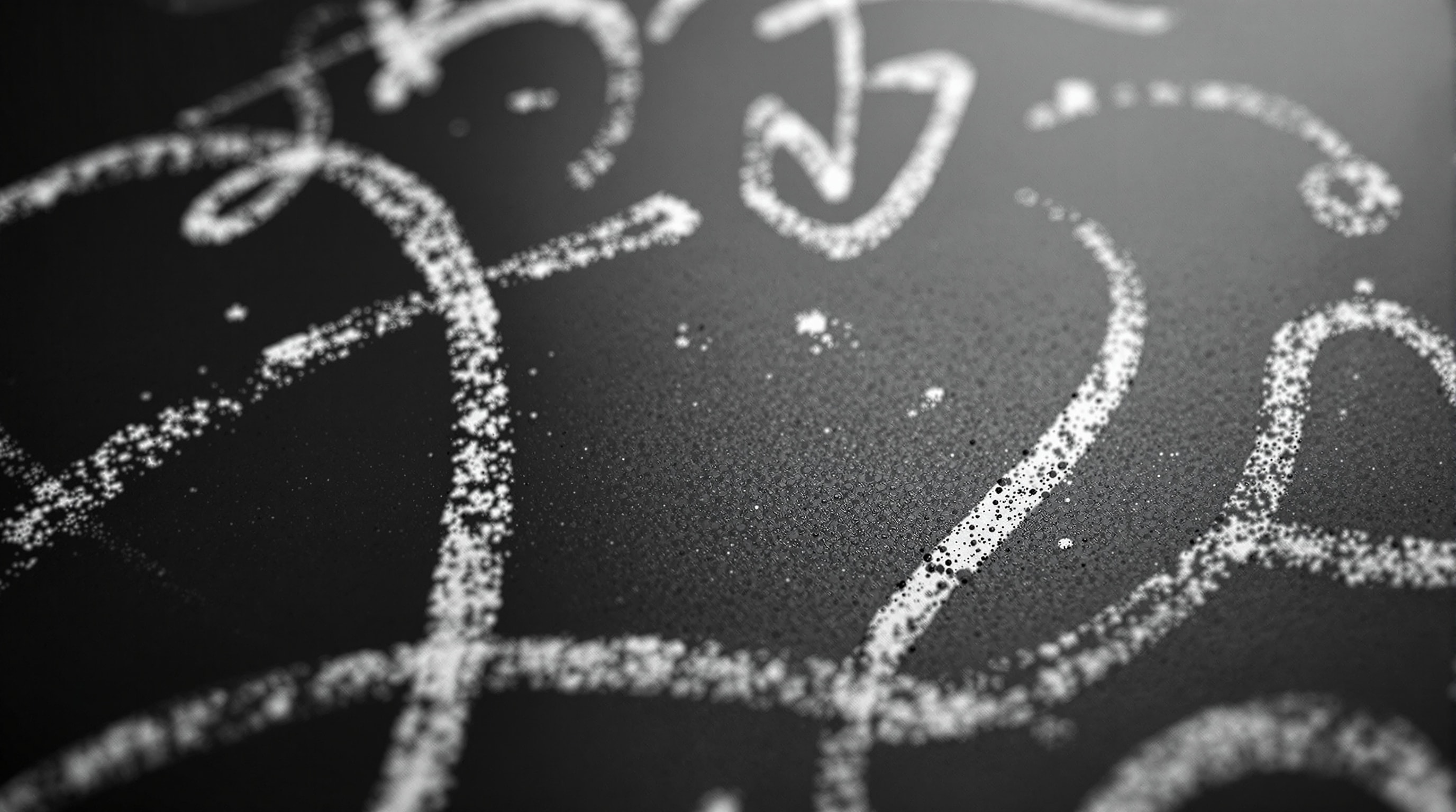 A slate tactics board covered in abstract chalk arcs and dots